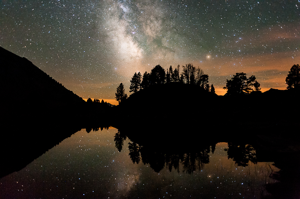 Milky way reflected in a mountain lake. Pyrénées, France