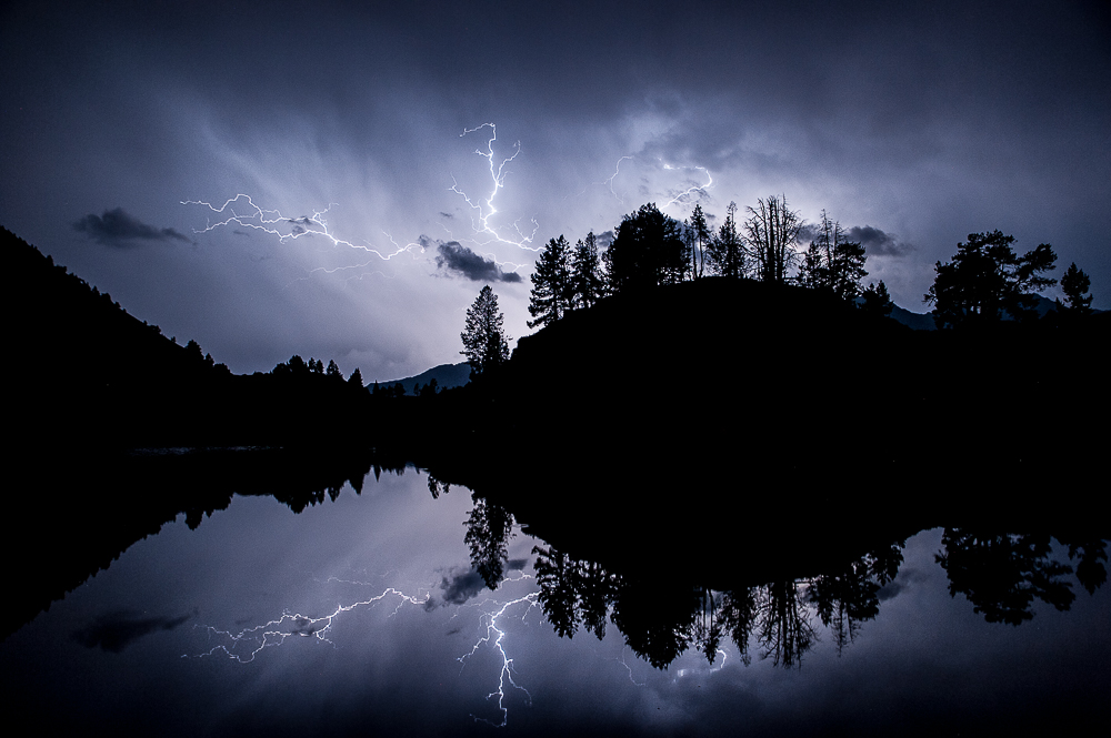 Storm reflected in a hidden lake, Pyrénées, France.